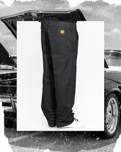 Person wearing black jeans and white shoes in front of a car.