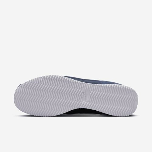 Bottom view of a blue sneaker with a white textured sole.