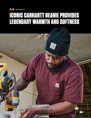 Man wearing Carhartt beanie using a drill.
