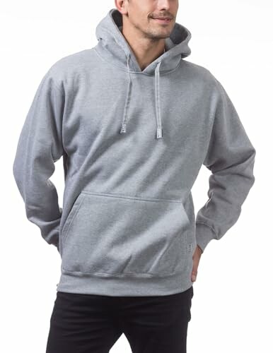 Man wearing a gray hoodie with hands in pockets