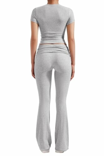 Back view of a person wearing a gray, fitted two-piece outfit.