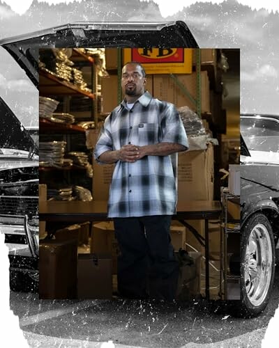 Man standing in a warehouse with boxes and shelves.