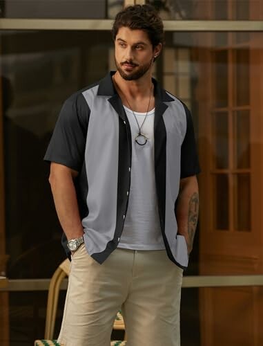 Man in a color-block short-sleeve shirt and shorts.