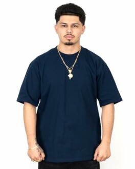 Man wearing a navy blue t-shirt with gold necklaces.