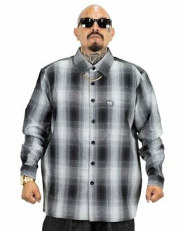 Person in sunglasses wearing a black and white plaid shirt.