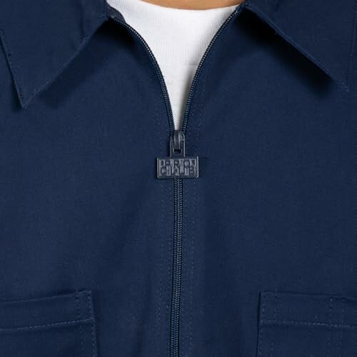 Close-up of a navy blue zipper jacket with pockets.
