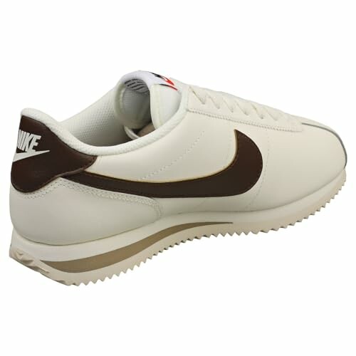 White and brown Nike sneaker, side view.