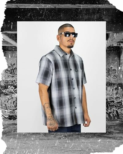 Man wearing plaid shirt and sunglasses.