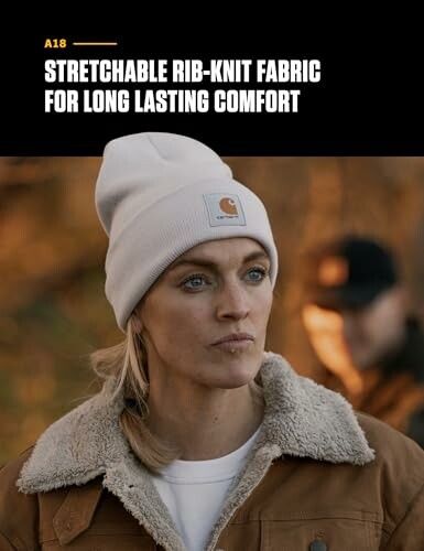Person wearing a white rib-knit beanie and a brown jacket outdoors.