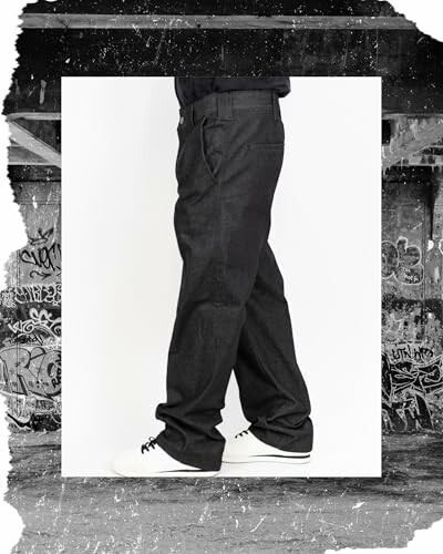 Person wearing dark jeans and white sneakers with a graffiti background.