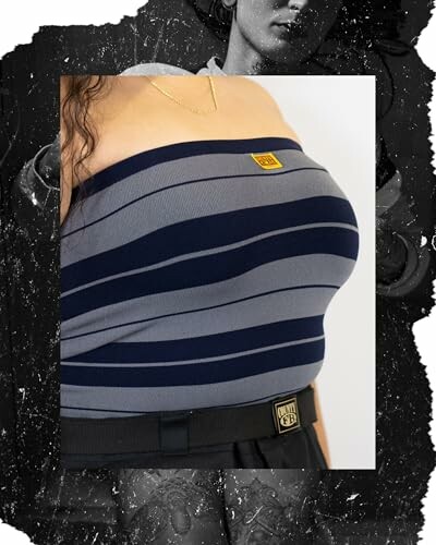 Person wearing a striped tube top with a gold necklace