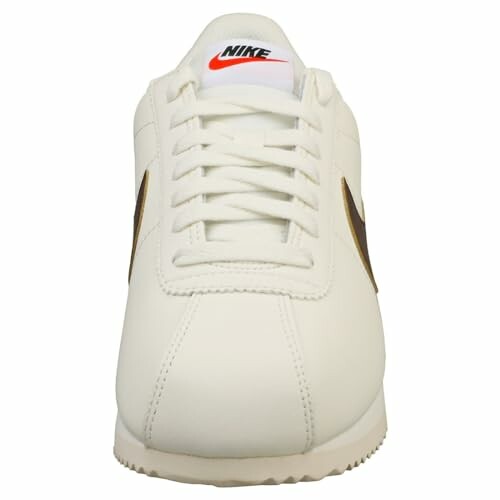 Front view of white Nike sneaker with red logo