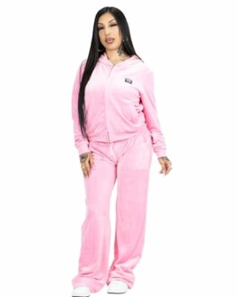 Woman wearing a pink velour tracksuit.
