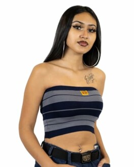 Woman wearing a striped tube top with hoop earrings.